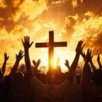 Download Group of crowd of Christians raise their hands in the air worshiping the cross_ Religion concept of faith and prayer with bright sunset for free